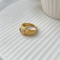 Macro shot of gold-plated ring featuring a large clear gemstone and textured wide band - US 6 / Diamond White