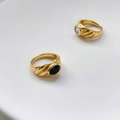 Macro shot of gold vintage rings with textured bands and emerald-cut stones - US 6 / Charming Black