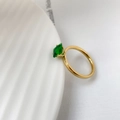 Detailed view of square green zircon stone on a minimalist golden band ring - US 6 / Green Zirconia