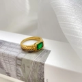 Macro shot of an emerald-cut green stone ring with textured gold band on white fabric - US 6 / Textured Band Style (Small Green)