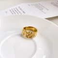 Close-up of golden lava texture ring with irregular pleated design on ceramic tray - US 6 / Lava Style