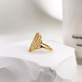 Detail showing golden peacock-inspired hollow fan design ring on stone base - US 6 / Peacock Style