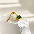 Nahaufnahme eines Smaragd-Zirkonia-Rings mit goldener Kette auf weißem Stein - Einheitsgröße Verstellbar / Verstellbarer Kordelzug Quadratischer Grüner Stein Stil