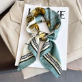 Fashionable floral print silk scarf in mint green and gold draped on a beige blazer - Large Square / Aqua