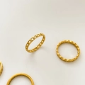 Detailed macro view of four minimalist gold chain and geometric rings on light background - US 6 / Fine Chain