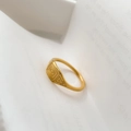 Detailed close-up of a gold signet ring with engraved geometric patterns on white paper - US 6 / Square Pattern
