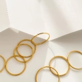 Close-up of gold stacking rings set with black zircon and sparkling pavé diamonds - US 6 / Black Zirconia Style