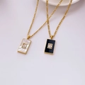 Detail of gold Figaro necklaces with rectangle shell pendants and zircon stones - Black Agate Zirconia
