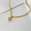 Detail of gold Cuban chain necklace with oval clear crystal pendant and adjustable link - Small Clear Oval