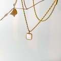 Détail d'un pendentif carré en nacre monté sur une chaîne torsadée dorée élégante - Nacre Blanche Carrée Simple Couche