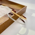 Detailed view of quilted pattern texture on gold and silver plated titanium steel bangles - Quilted Pattern Gold Open Cuff