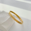 Detailed view of an 18K gold plated titanium bangle featuring a triple-groove texture - Striped Gold (Inner Diameter 5*6cm)
