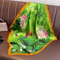 Elegant lotus silk square scarf with green water lily print and orange hem on leather sofa - 70cmx70cm / Green