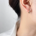 Detailed close-up of small golden hoop earrings featuring micro light blue zircon stones - Light Blue Zirconia (1.2cm)