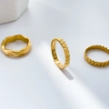 Detailed view of 18K gold plated rings with wave, gear, and striped textured surfaces - Gear Pattern