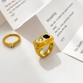 Makroaufnahme von 18K vergoldeten Ringen mit Lavatextur, schwarzem Zirkon und Herz-Kristall - US 6 / Schwarz-weißer Zirkon