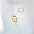 Close-up of golden beaded heart ring and minimalist round disc ring set on white surface - US 6 / Heart Bead