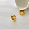 Detail of two gold-finish rings featuring a wide open band and textured wave design - US 6 / Small Gourd