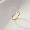 Macro view of slim golden tungsten ring featuring minimalist geometric faceted textures - Double Layer Cut
