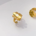 Detailed close-up of a golden daisy ring with white enamel petals and flower center - US 7 / Daisy (Adjustable Size 7)