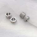 Detail showing two styles of silver geometric ear cuffs on white textured mesh background - Threaded Ear Buckle Steel Color (Width 0.6cm Diameter 1.3cm)