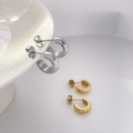 Detail view of silver and matte gold C-shape geometric hoop earrings on ceramic - Small C-Shape Gold (Diameter 1.3cm)