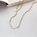 Close-up of 18K gold plated necklace with delicate freshwater pearls and metal bean beads - Rice Pearl Bead Necklace