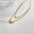 Detailed close-up of a double-layered gold butterfly necklace with intricate shell patterns - Double Layer Butterfly