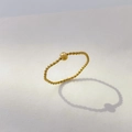 Detail eines 18K vergoldeten Titanstahl-Ringes mit beweglicher, polierter Goldperle - US 6 / Einzelne Perle Gedreht