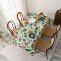Green rectangular tablecloth with vintage sunflower prints on a dark dining table - Sunflower