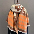 Close-up of thick scarf detail showing vintage floral patterns and fringe edges - Orange Coffee