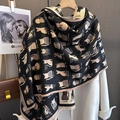 Detailed view of cat pattern knit scarf with soft cashmere-like texture and fringed edges - Black