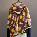 Close-up of winter jacquard scarf with cartoon cat patterns and fringe detailing - Coffee Yellow
