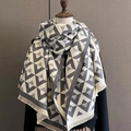 Close-up of geometric V-pattern cashmere-feel scarf with elegant fringe and soft texture - Light Gray