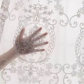 Detailed close-up of white floral embroidery on translucent lace sheer curtain fabric - Size 100x200 / White