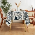 Detail of blue and white linen tablecloth featuring floral patterns and fringe edges - 140*100 / Apple Flower (Beige Tassels)