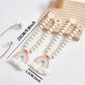 Close-up of bohemian rainbow curtain tieback with wooden beads and white cotton tassel - One Size / Pink