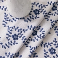 Close-up of blue floral cotton linen tablecloth with heavy drape and natural texture - 60*60cm / Abundant Flowers
