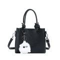 Black pebble leather bucket bag featuring a cute white plush monster charm and top handles - Black