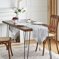 Grey and silver wave pattern table runner with matching tassels on a wooden dining table - Silver Gray