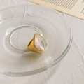 Macro detail of gold ring with teardrop pearl shell inlay placed in a glass tray - US 6 / Large Shell Heavy