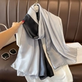 Close-up of elegant gradient satin silk scarf draped on a leather background - 90*180cm / Black Grey Gradient