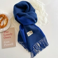 Close-up of navy blue double-sided scarf with elegant tassels and brand woven label - Royal Blue