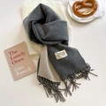Detail of double-sided cashmere scarf showing soft texture, fringes and logo label - Deep Heather Grey