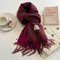 Detail of burgundy cashmere feel scarf showing twill texture, tassels, and chic accessories - Burgundy