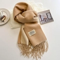 Detail of camel cashmere-like scarf showing soft tassels and minimalist fabric label - Khaki Beige