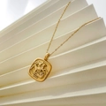 Detail of gold square coin pendant with embossed horse rider motif and 1932 engraving - Galloping Horse