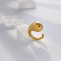 Detailed view of polished golden fluid teardrop sculpture ring with clear crystals - Hollow Tadpole Shape
