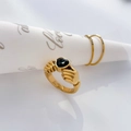 Macro detail of gold Claddagh ring with black heart zircon held by hands design - US 6 / Black Zircon Heart Hugging Hands