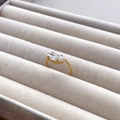 Detailed shot of a gold marquise-cut zircon ring on a grey velvet jewelry box display - US 6 / Thin Ring Marquise Zircon
